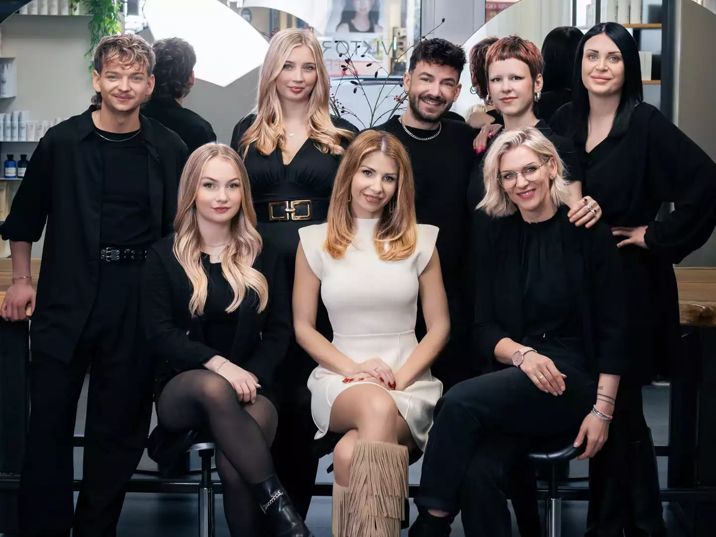 Friseurteam im Salon: Stylisten und Kundin, Haarstyling und Beratung